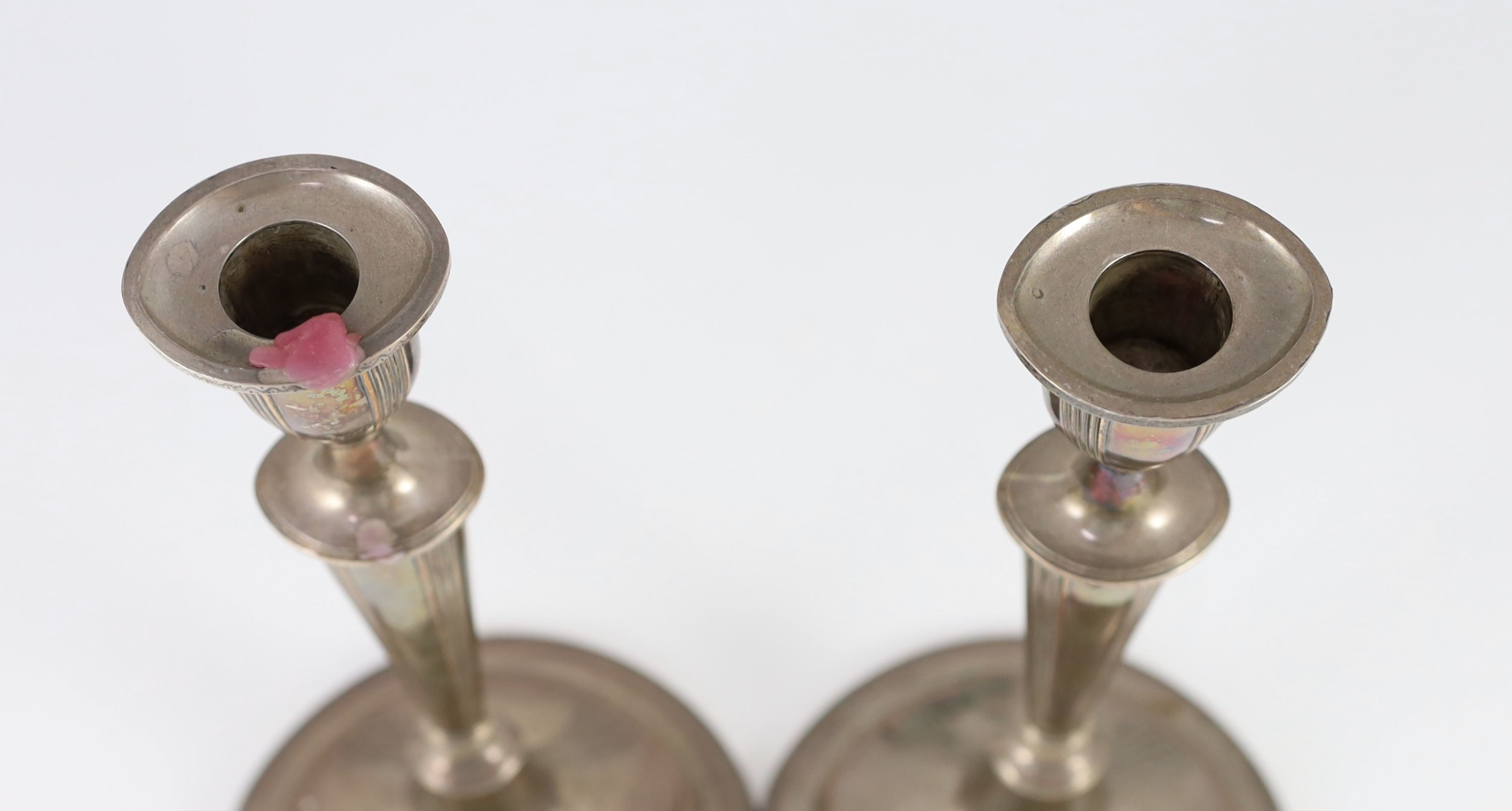 A pair of Sheffield plate candlesticks and nozzles, 32cm high